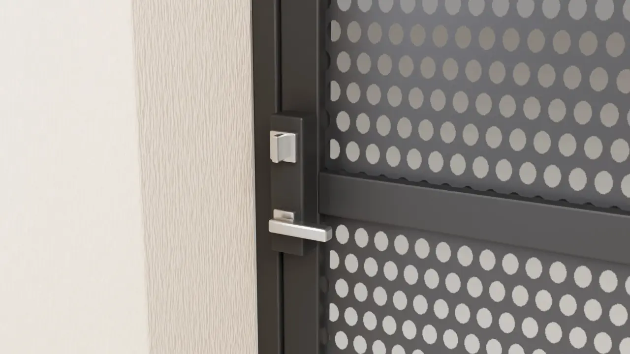 3D close-up from inside the house of a black security screen door's latch side: a satin steel thumb-turn above a lever handle on the lock body, perforated steel screen and the mounting frame beside a stucco wall